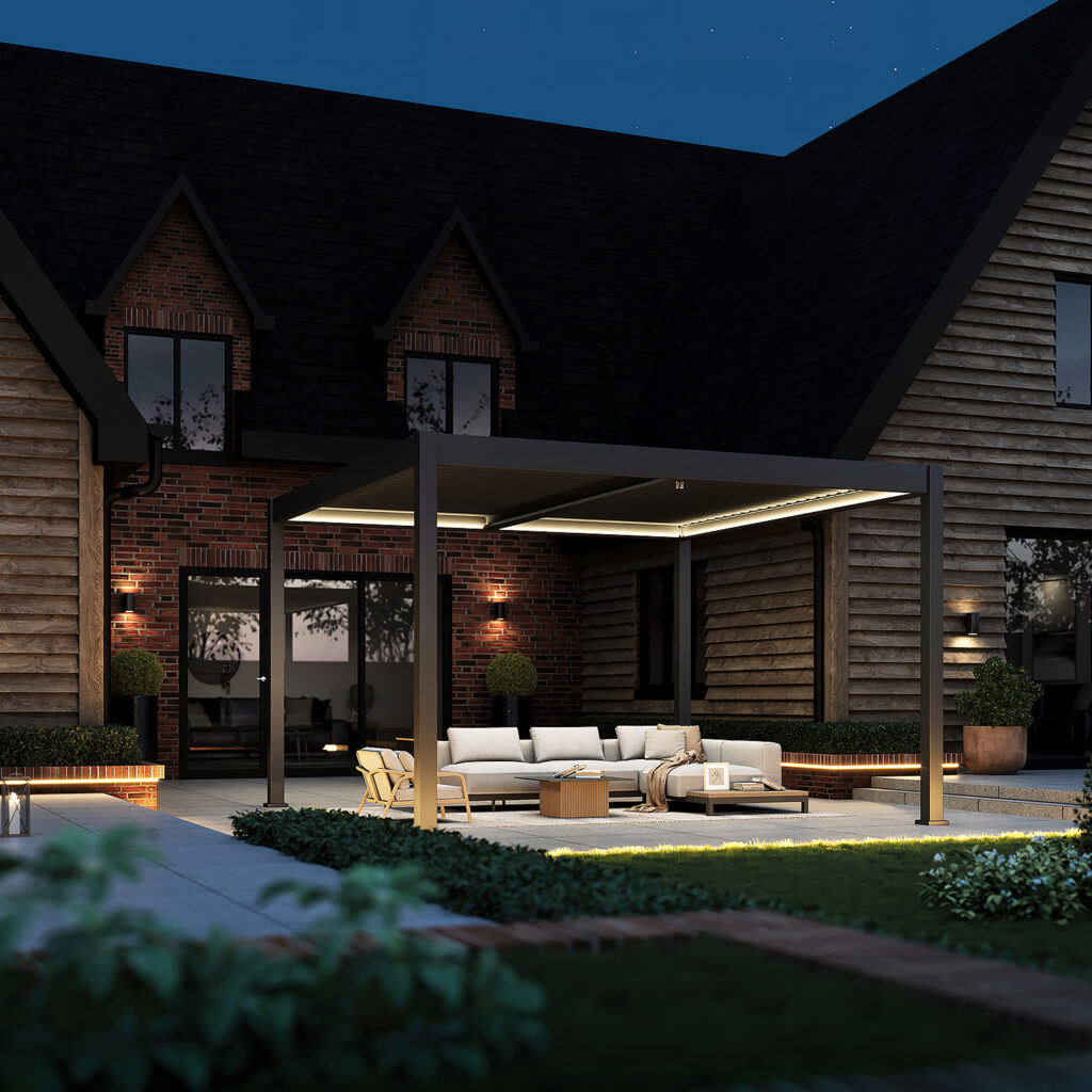 Modern dark grey pergola with LED lighting and integrated side blinds, placed on a deck outside a red-brick house with lawn edging and ambient garden lighting.