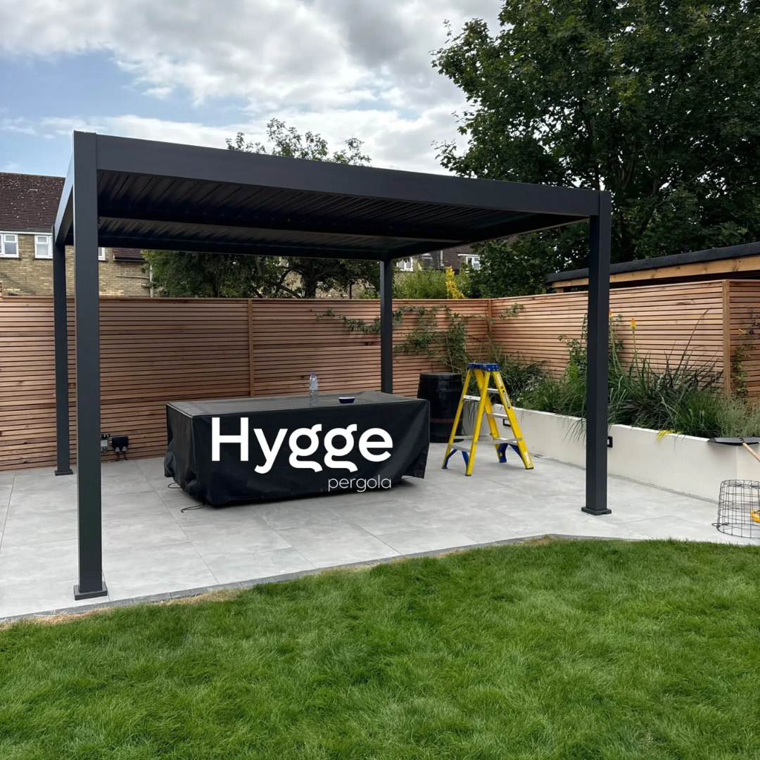 Large outdoor pergola with adjustable roof louvres and windproof retractable blinds.