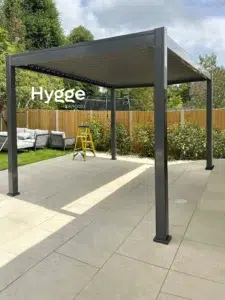 Luxury dark grey aluminium pergola with privacy screens, perfect for modern outdoor living.